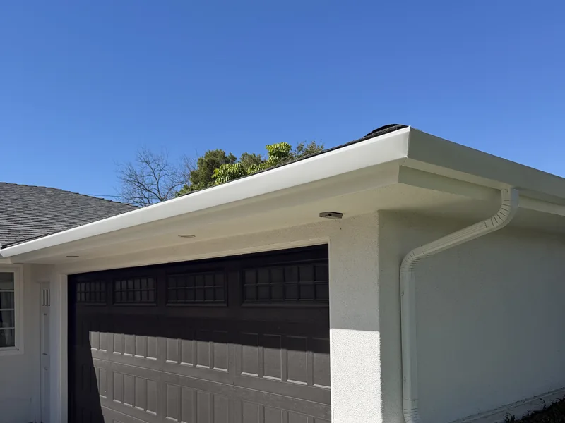 White seamless gutter and downspout installed on a Tustin home