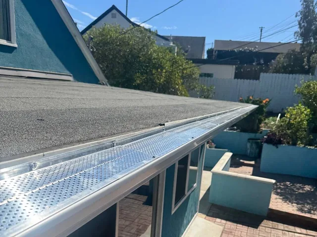 Micro-mesh gutter guard installed over a residential gutter